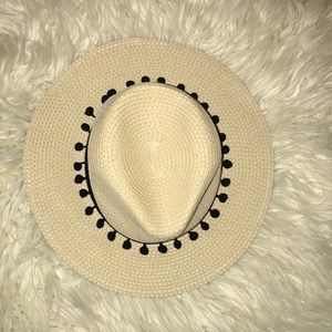 Tan beach hat with black Pom Pom detail